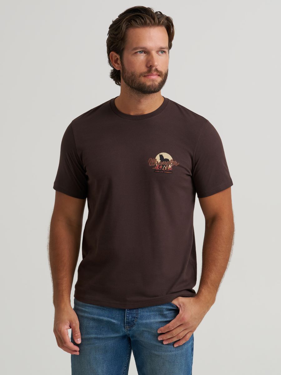 Man wearing a brown Wrangler t-shirt with a logo on a plain background