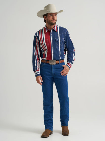 Man wearing a colorful striped Wrangler shirt, blue jeans, and a cowboy hat on a gray background