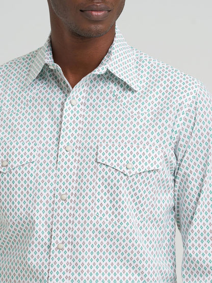 Man wearing a green and brown patterned Wrangler shirt  against a plain background