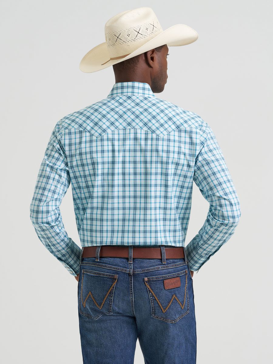 Man wearing a blue plaid Wrangler shirt, jeans, and a cowboy hat on a light gray background