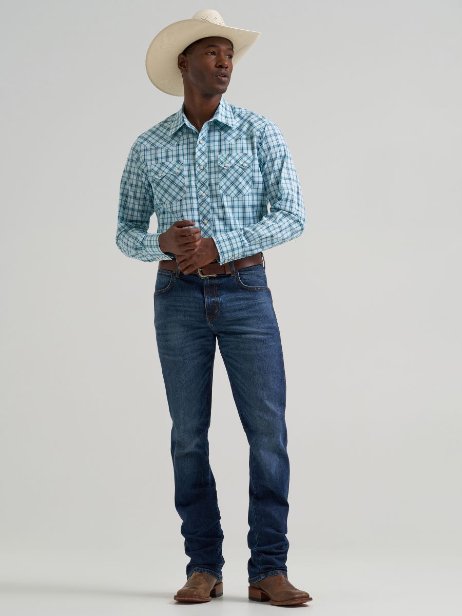 Man wearing a plaid Wrangler shirt, jeans, and cowboy hat on a plain background