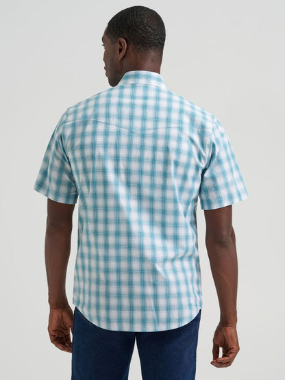 Man wearing a blue and white checkered Wrangler shirt against a plain background