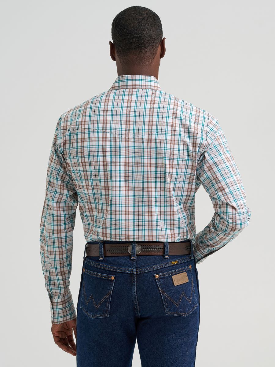 Man wearing a brown plaid Wrangler shirt and blue jeans on a plain background