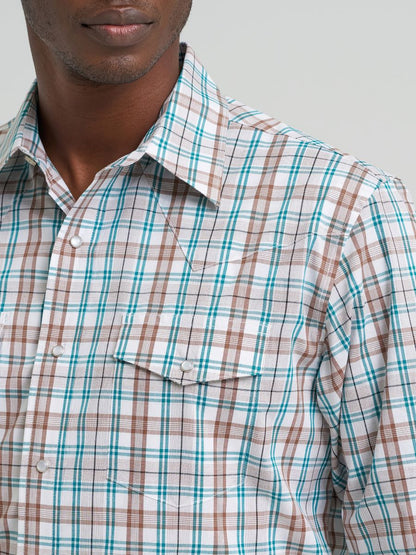 Man wearing a plaid Wrangler shirt with green and brown pattern on a gray background