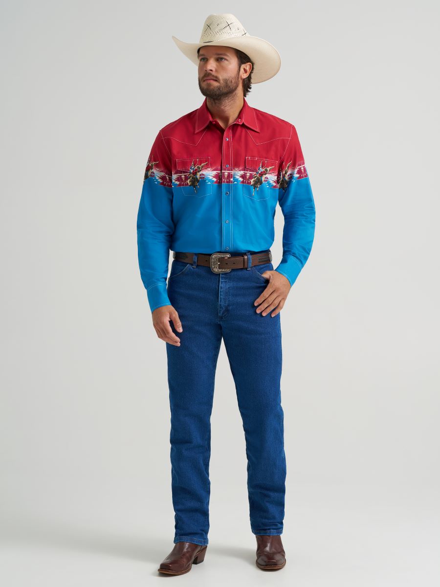 Man wearing a red and blue patterned Wrangler shirt with blue jeans and a cowboy hat on a white background