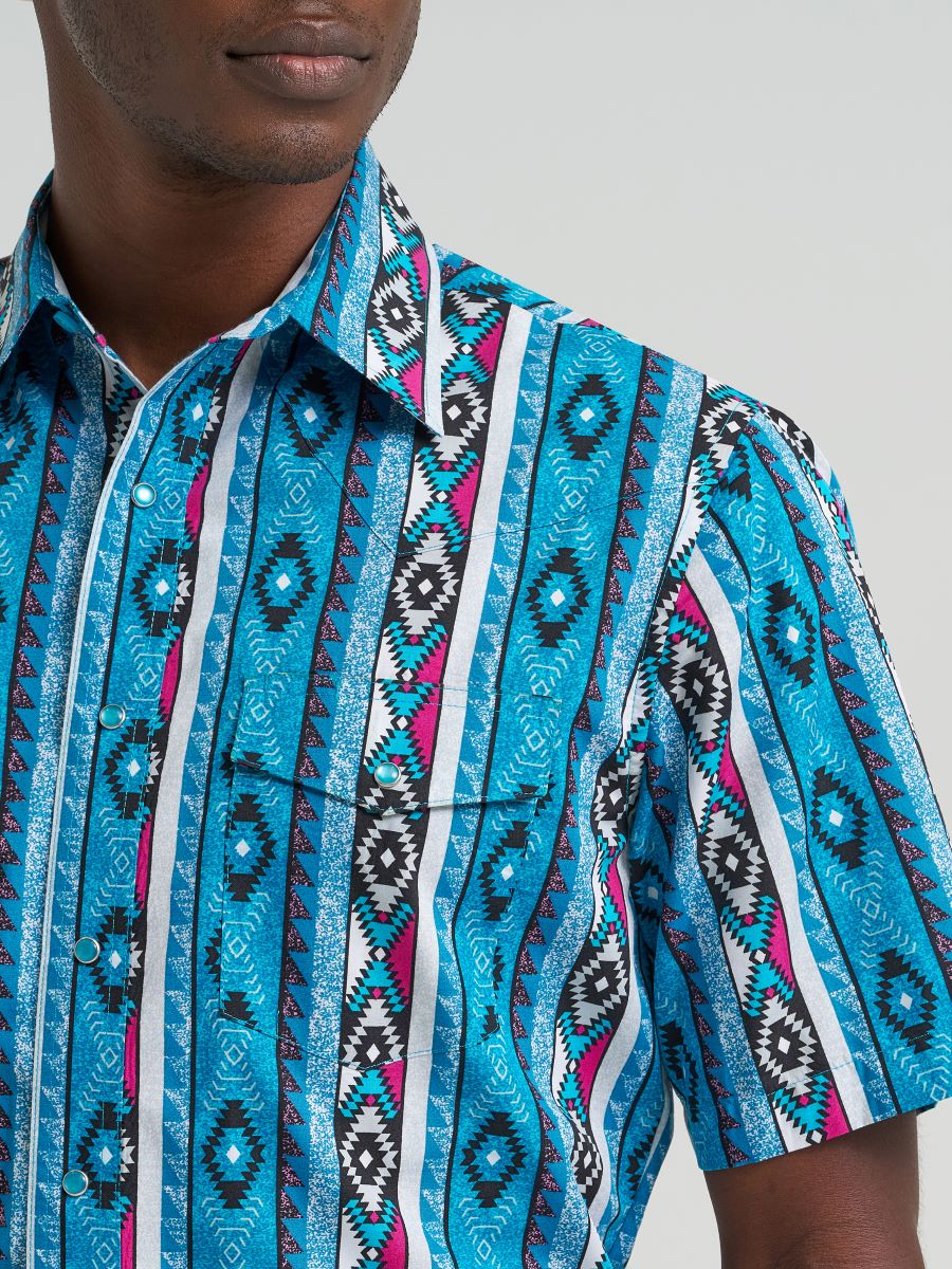 man wearing a Blue Wrangler shirt  on a grey background