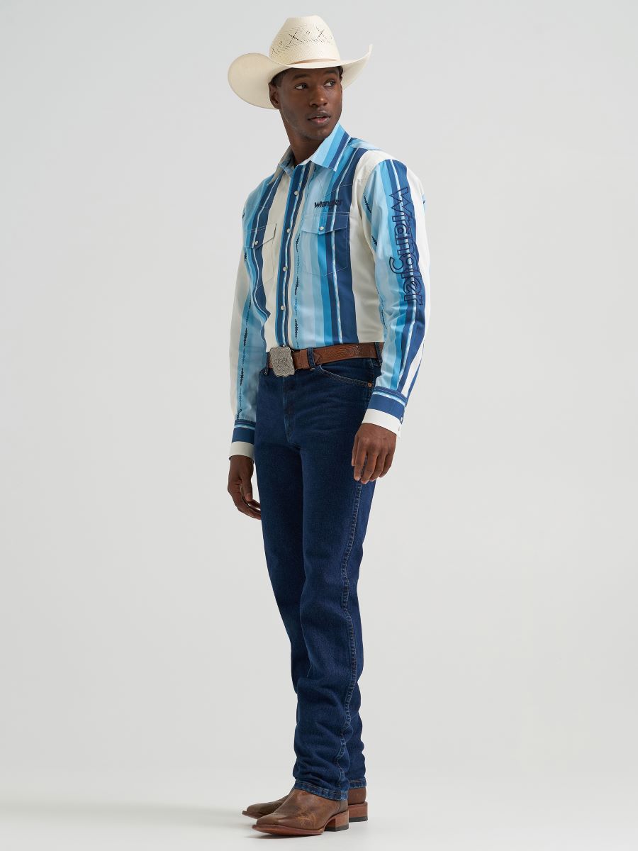 Man wearing a blue striped Wrangler shirt and jeans with a cowboy hat on a light gray background