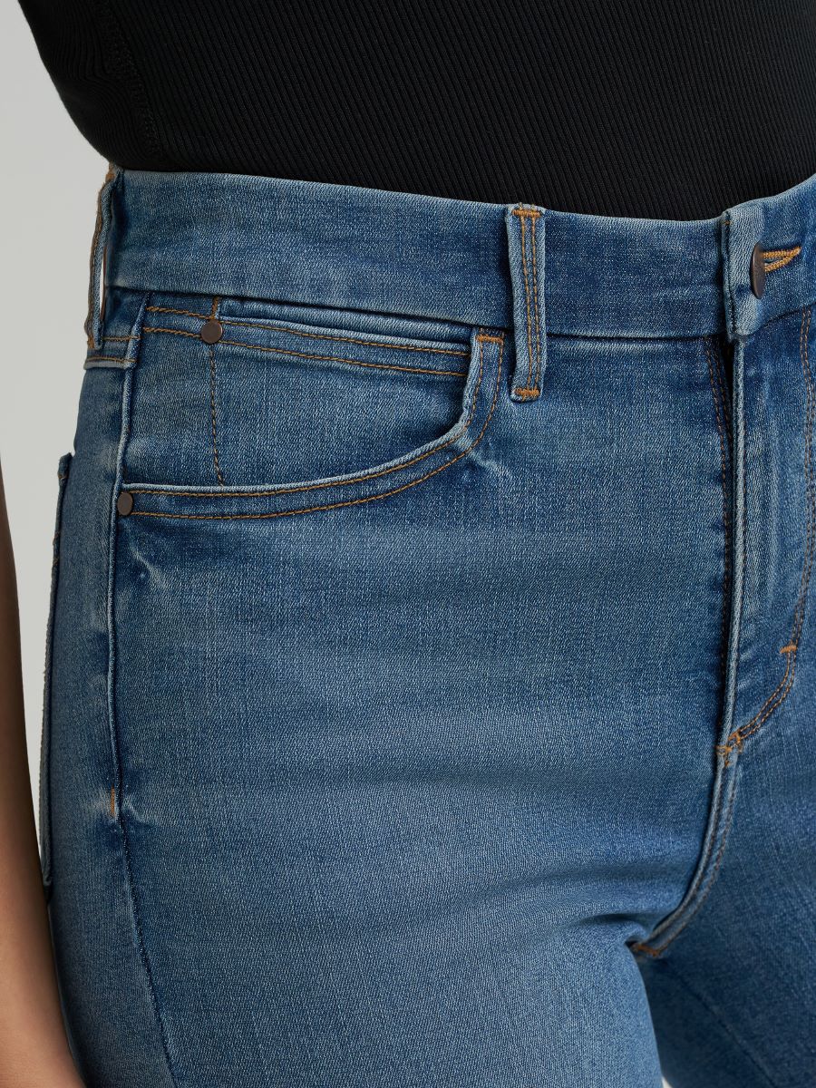 Close-up of blue jeans with a plain background
