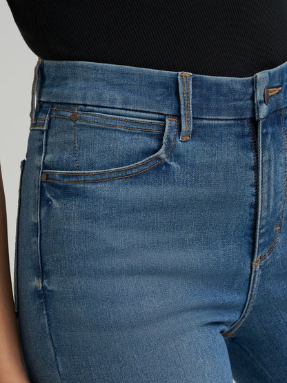 Close-up of blue jeans with a plain background