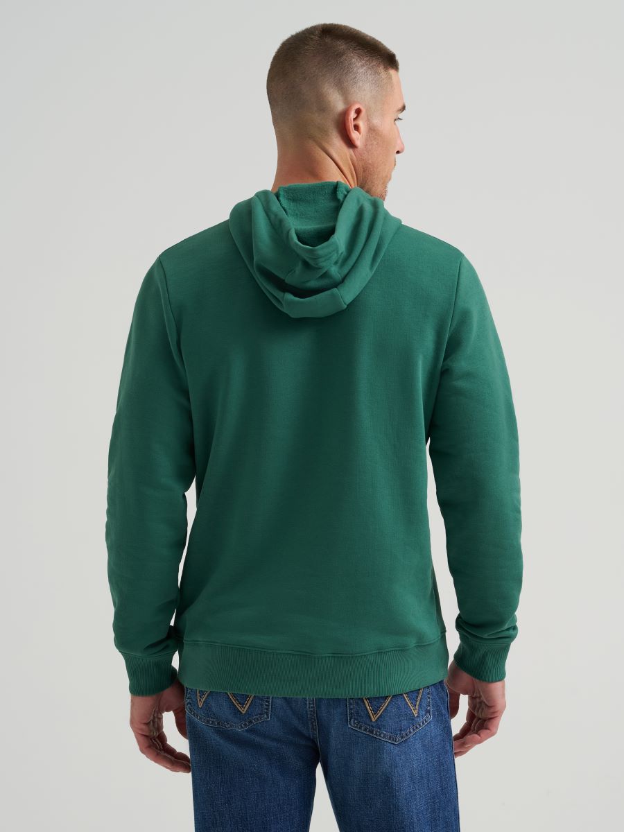 Man wearing a green Wrangler hoodie from behind on a light gray background