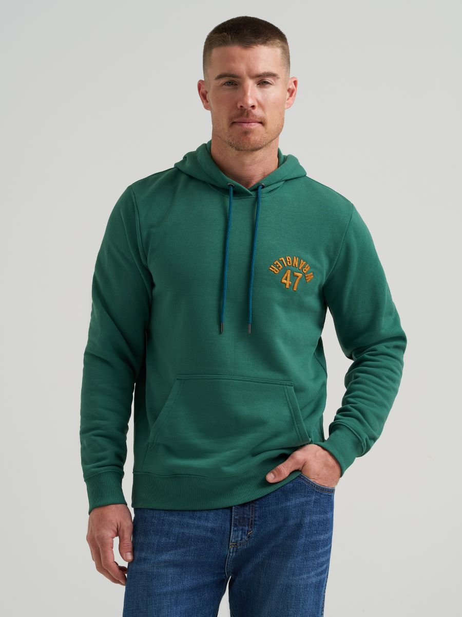 Man wearing a green Wrangler hoodie with text on a plain background