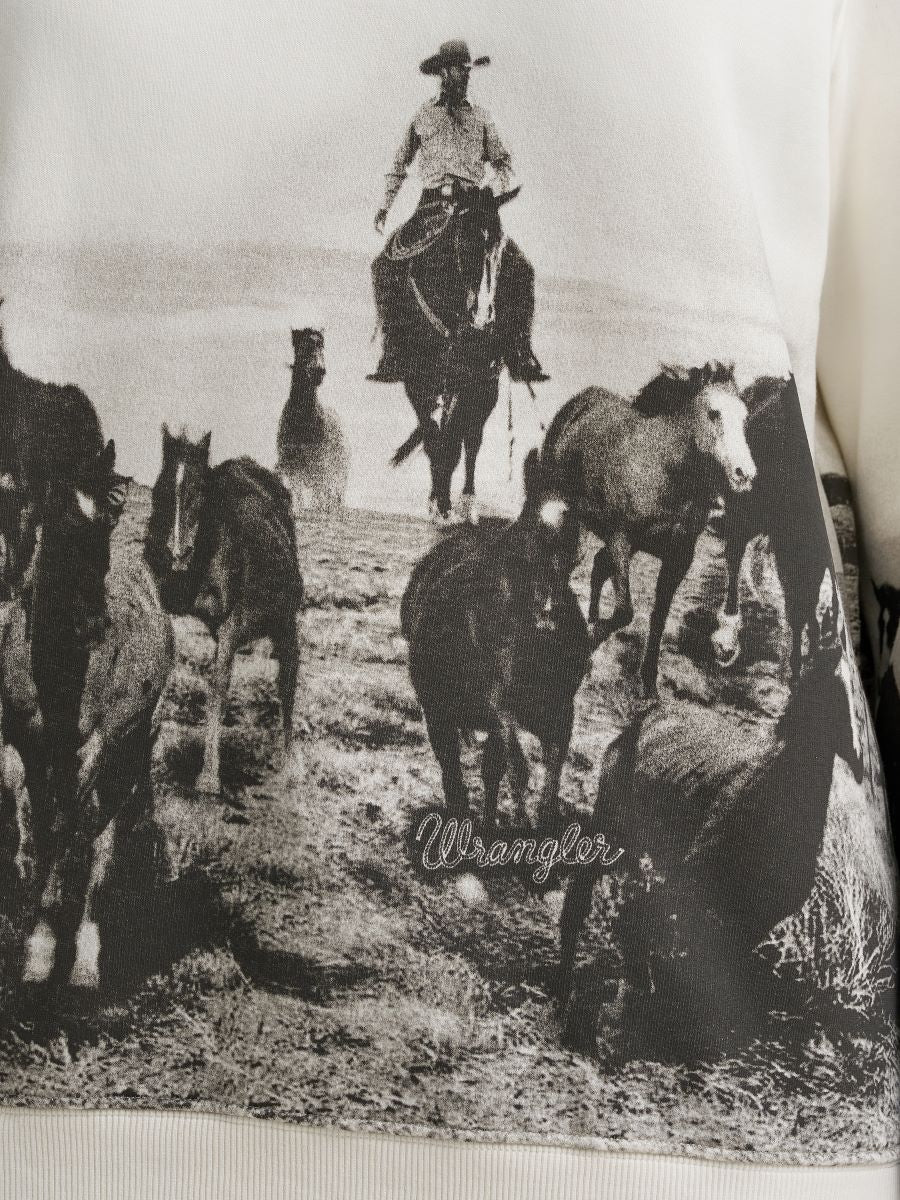 Vintage-style advertisement for Wrangler featuring a cowboy on horseback with other horses.