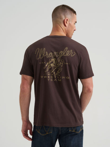 Man wearing a brown 'Wrangler Wrestling Team' t-shirt on a light gray background