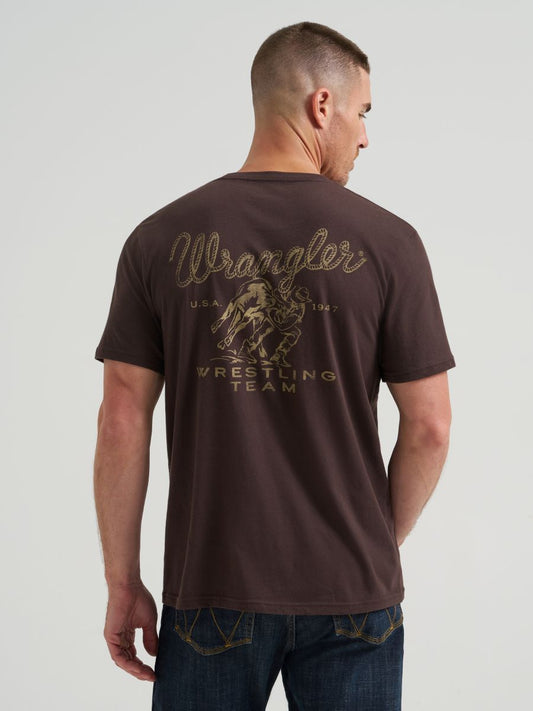 Man wearing a brown 'Wrangler Wrestling Team' t-shirt on a light gray background