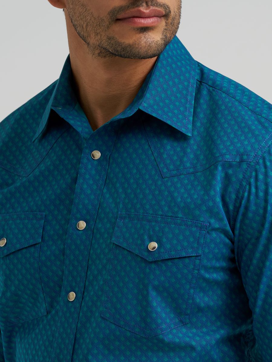 Close-up of a blue patterned Wrangler shirt worn by a person on a gray background