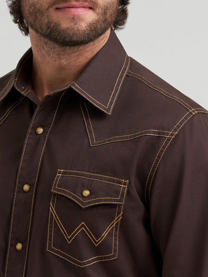 Close-up of a brown Wrangler shirt with detailed stitching on a white background