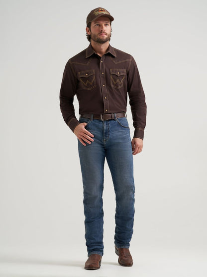 Man wearing a brown Wrangler shirt, blue jeans, and a cap on a white background