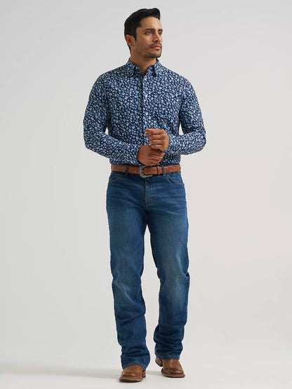 Man wearing a blue Wrangler shirt and blue jeans on a white background