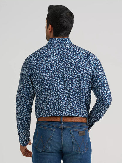 Man wearing a blue Wrangler shirt and blue jeans on a white background