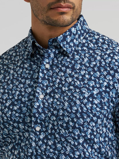 man wearing a blue floral Wrangler shirt on a white background