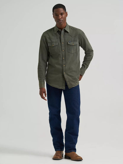 man wearing a green denim Wrangler shirt and blue jeans on a white background