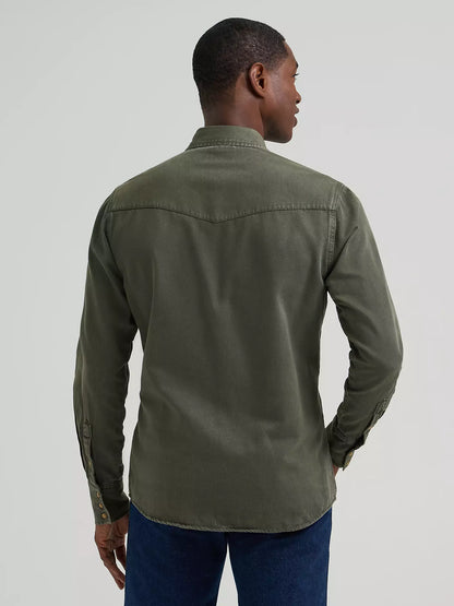man wearing a green denim Wrangler shirt and blue jeans on a white background