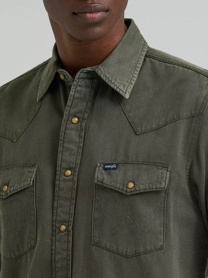 man wearing a green denim Wrangler shirt on a white background