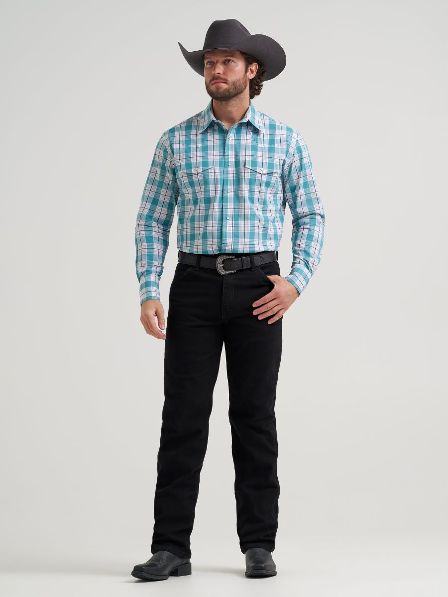 Man wearing a plaid Wrangler shirt and black pants on a white background