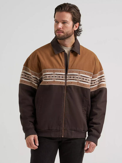 Man wearing a brown Wrangler bomber jacket and black jeans on a white background