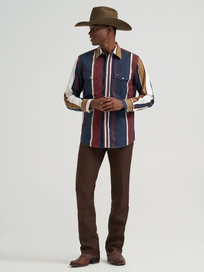 Person wearing a striped Wrangler shirt and cowboy hat on a plain background