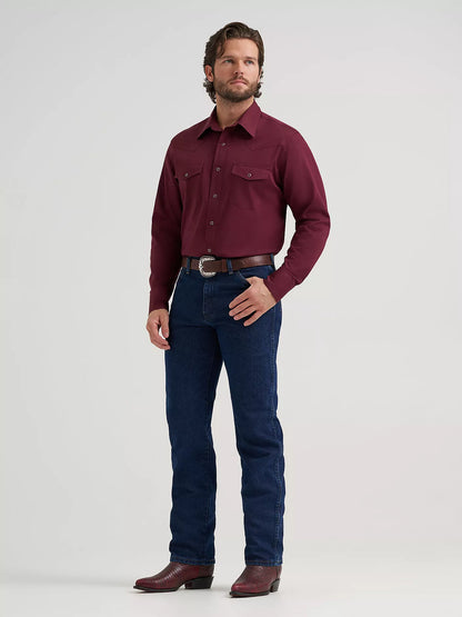 man wearing a burgundy Wrangler shirt, blue jeans and boots on a white background