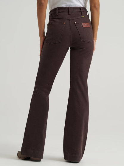 woman wearing brown Wrangler jeans and a white shirt on a white background