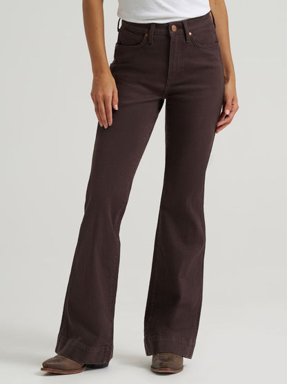 woman wearing brown Wrangler jeans and a white shirt on a white background