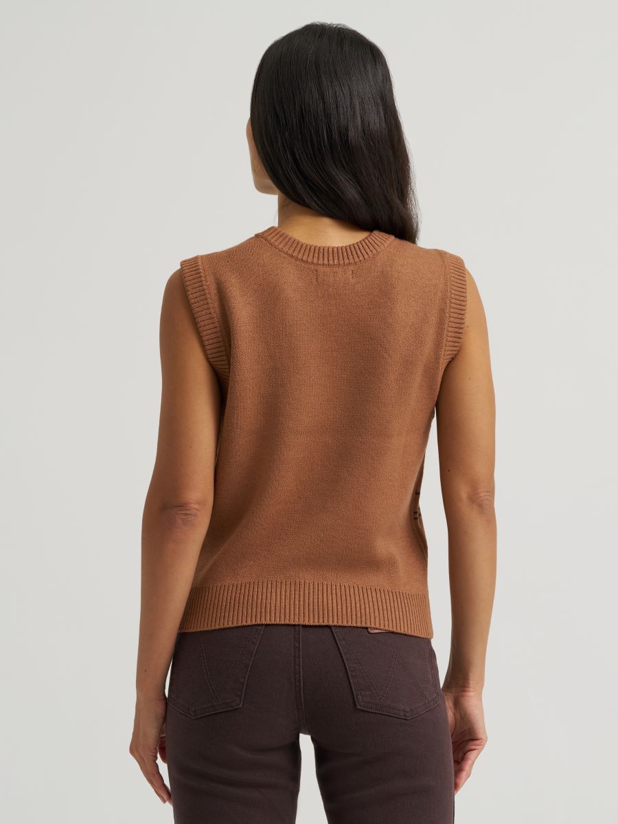 Person wearing a brown sleeveless Wrangler sweater against a plain background