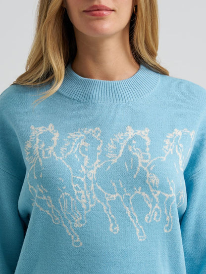 Light blue Wrangler sweater with horse design worn by a person