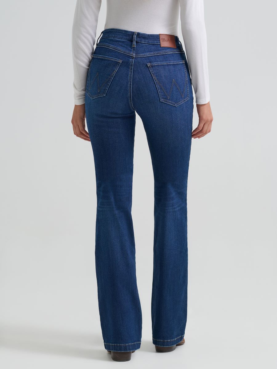 Person wearing blue Wrangler jeans on a white background