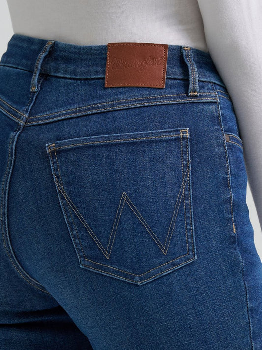 Person wearing blue Wrangler jeans on a white background