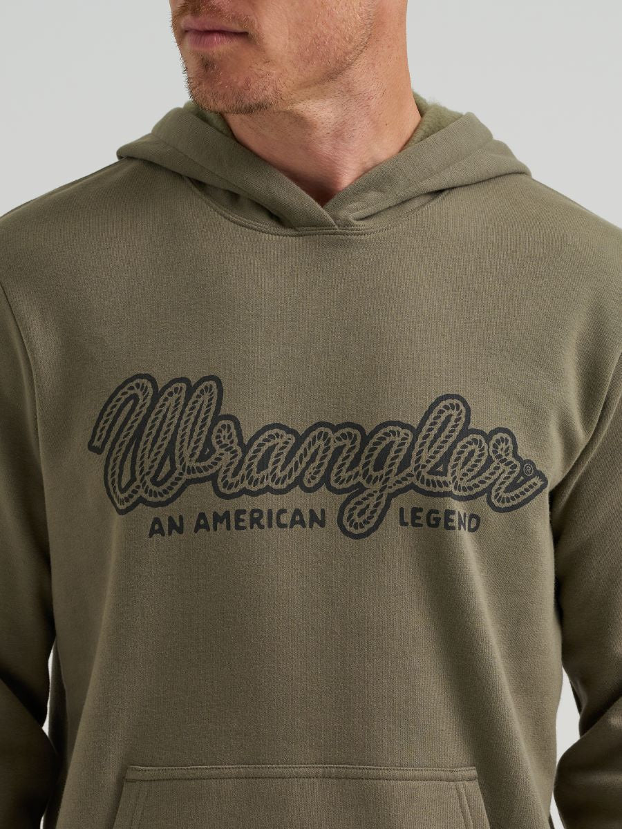 Close up of a man wearing a green Wrangler hoodie on a grey background