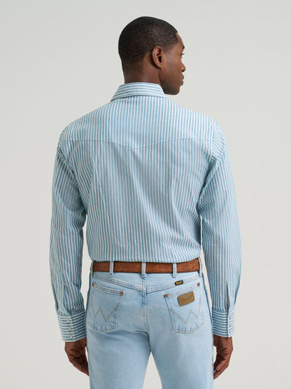 Man wearing a blue striped Wrangler shirt and blue jeans on a grey background