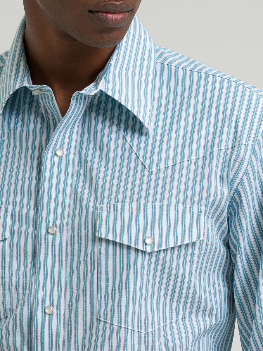 Man wearing a blue striped Wrangler shirt on a grey background