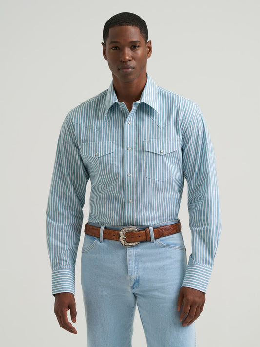 Man wearing a blue striped Wrangler shirt and blue jeans on a grey background