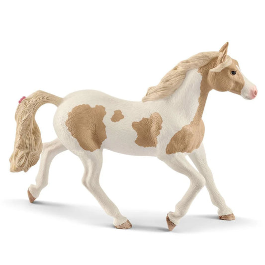 Model Schleich horse with a white body and brown patches on a white background