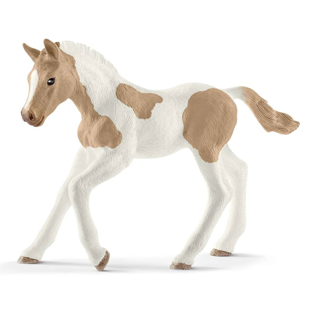Schleich Model horse with white body and brown patches on a white background