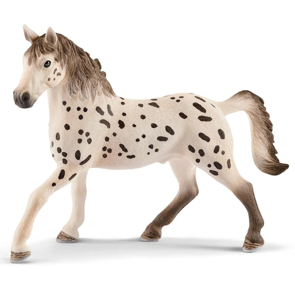 Schleich toy horse with spotted coat on a white background