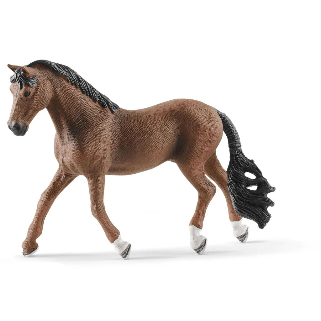 A Schleich toy figurine of a Trakehner horse with a brown body, black mane and tail, and white feet and head detail.