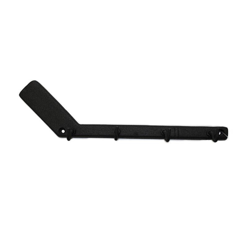 Cast iron hockey stick shaped key rack by Koppers on a white background