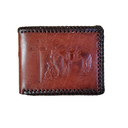 leather wallet with laced edge and a image of a horse and man kneeling by a cross on a white background