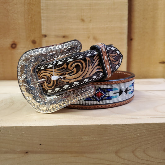 Leather belt by angel ranch with beading and craving detail and a bling belt buckle on a wooden background