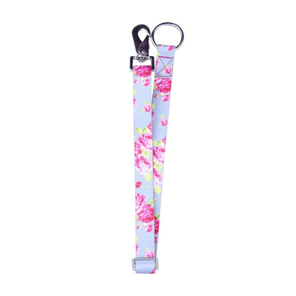Blue and pink rose printed nylon webb strap with a clip and hardware loop on a white background