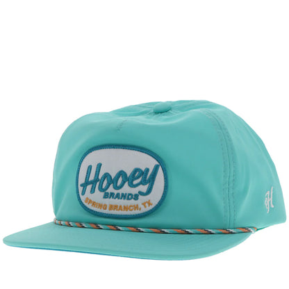 a turquoise slouchy cap by hooey with a patch that says 'hooey brands'